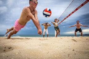 Friends Play Beach Volleyball On Hot Melbourne Day