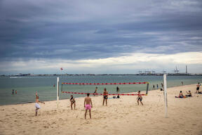 Friends Play Beach Volleyball On Hot Melbourne Day