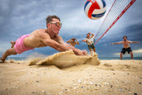 Friends Play Beach Volleyball On Hot Melbourne Day